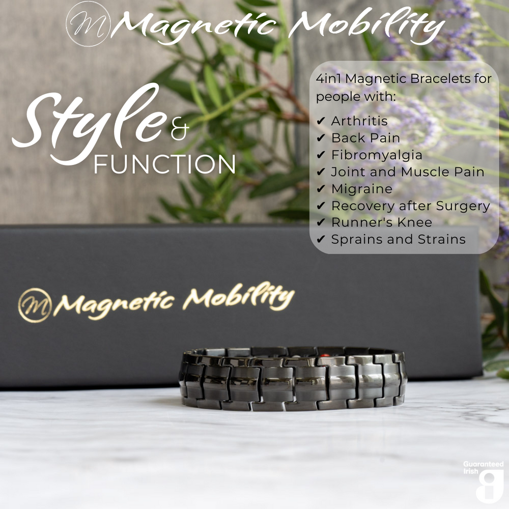 Front view of the Ashe Night Double strength 4in1 magnetic bracelet by Magnetic Mobility, promoting arthritis, back pain, fibromyalgia relief with a stylish black design. The bracelet is shown in front of its luxury Black gift box and flowers.