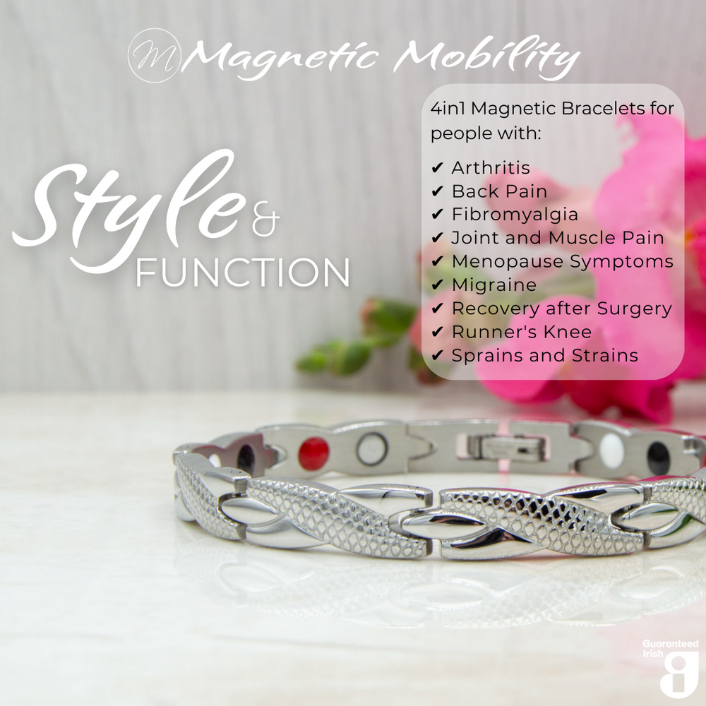 Close up view of the Snapdragon Star 4in1 magnetic bracelet by Magnetic Mobility. Shown on a reflective surface with pink flowers in the background. The text says "Style and Function"