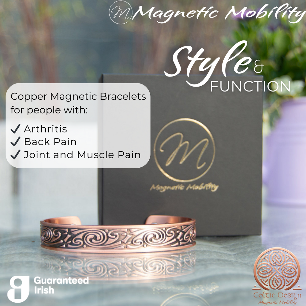 Front view of the Feverfew Copper bracelet from Magnetic Mobility. A copper bracelet with a Celtic design. Featuring 6 strong neodymium magnets. Perfect for people with arthritis and back pain. 99% pure copper. the image shows the bracelet in front of a black gift box and flowers. Part of the Celtic Collection from Magnetic Mobility.