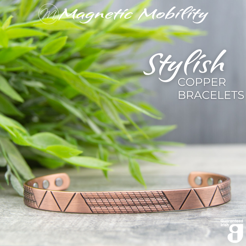 Front view of the Soloman Copper bracelet from Magnetic Mobility. A copper bracelet with a modern design. Featuring 6 strong neodymium magnets. Perfect for people with arthritis and back pain. 99% pure copper. the image shows the bracelet in front of a green plant