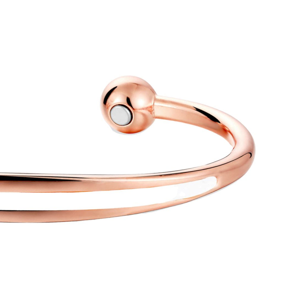 
                  
                    Load image into Gallery viewer, Close up view of the Spindle Dawn Copper bracelet from Magnetic Mobility. A copper bracelet with a simple design and an white band in the centre. Featuring 2 strong neodymium magnets. Perfect for people with arthritis and back pain. 99% pure copper. 
                  
                