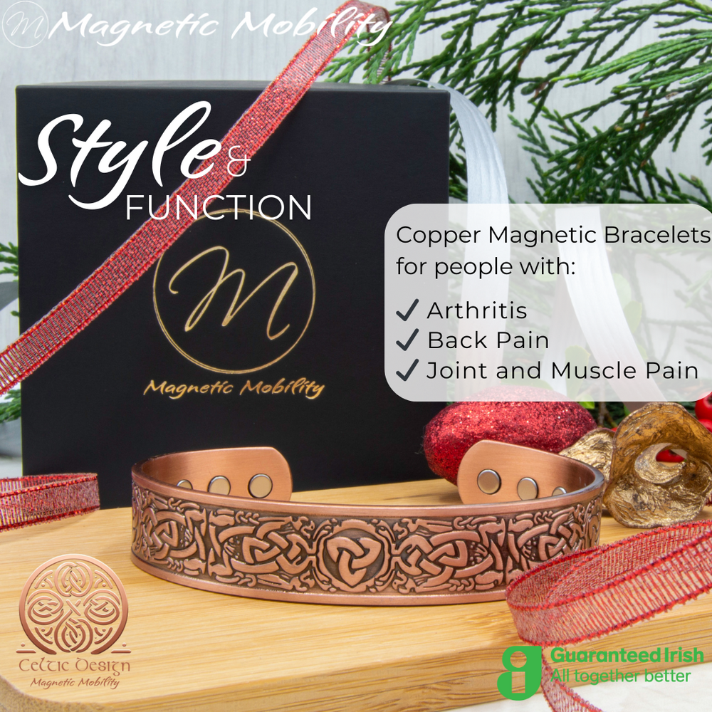 
                  
                    Load image into Gallery viewer, Front view of the Trinity copper bracelet by Magnetic Mobility. Shown on a wooden surface with a black gift box and Christmas decorations. The words &amp;quot;Style and Function&amp;quot; are written on the image along with &amp;quot;Copper Magnetic Bracelets for people with arthritis, back pain and more&amp;quot;. Part of the Celtic Collection. Features a guaranteed Irish logo. 
                  
                